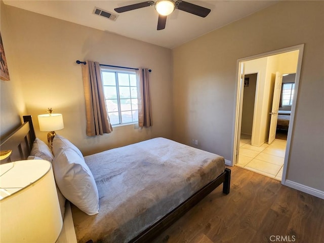 43620 Brahea Ct, Indio, CA 92201 - bedroom with multiple windows, wood finished floors, ceiling fan, and baseboards