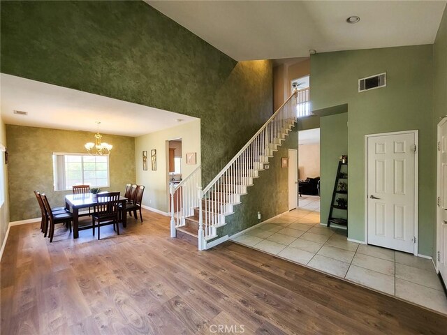43620 Brahea Ct, Indio, CA 92201 - entrance foyer featuring a towering ceiling, stairs, wood finished floors, a chandelier, and baseboards