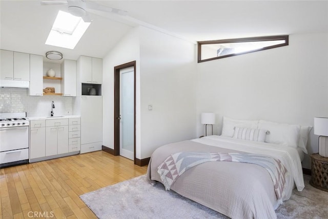 929 Lake St, Venice, CA 90291 - bedroom with a skylight, light wood-type flooring, a sink, lofted ceiling, and baseboards