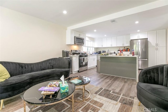 17465 Tuscan Dr, Granada Hills, CA 91344 - living room with light wood-type flooring and recessed lighting