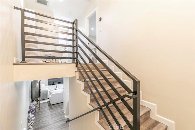17465 Tuscan Dr, Granada Hills, CA 91344 - stairs featuring wood finished floors, baseboards, and a towering ceiling