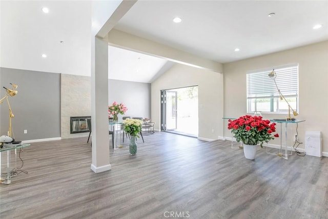 17465 Tuscan Dr, Granada Hills, CA 91344 - entrance foyer featuring vaulted ceiling, baseboards, wood finished floors, recessed lighting, and a large fireplace