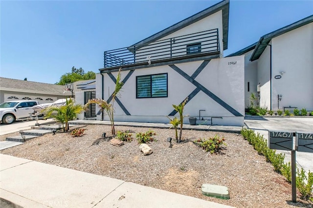 17465 Tuscan Dr, Granada Hills, CA 91344 - view of side of home featuring stucco siding and a balcony