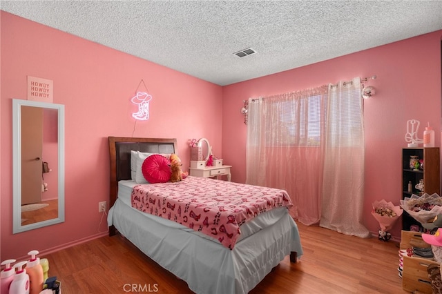756 W Fontlee Ln, Rialto, CA 92376 - bedroom with wood finished floors and a textured ceiling