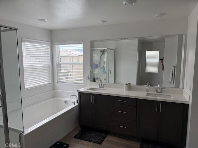 24581 Sonieta Ct, Corona, CA 92883 - bathroom with a shower stall, a garden tub, double vanity, and wood finished floors