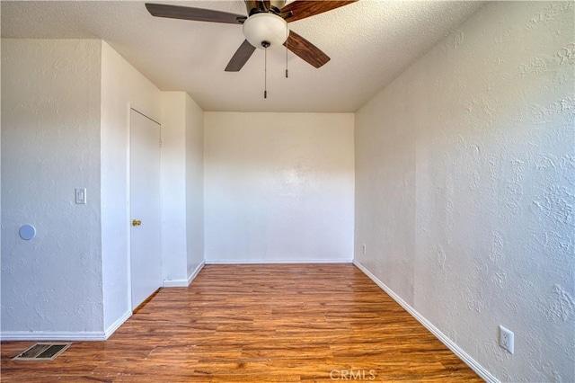 502 Robert Ct, Nipomo, CA 93444 - empty room featuring a textured wall, wood finished floors, a ceiling fan, and baseboards
