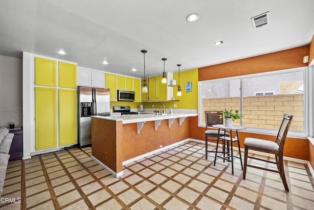 1531 Lakehurst St, Oxnard, CA 93030 - kitchen with stainless steel appliances, a peninsula, recessed lighting, a sink, and light countertops