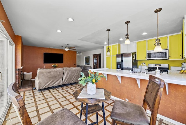 1531 Lakehurst St, Oxnard, CA 93030 - kitchen featuring stainless steel appliances, recessed lighting, a peninsula, tile countertops, and a ceiling fan