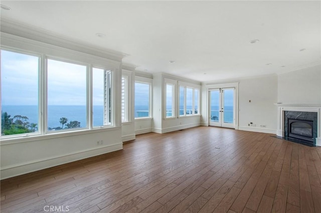 2163 Crestview Dr, Laguna Beach, CA 92651 - unfurnished living room with baseboards, french doors, plenty of natural light, hardwood / wood-style flooring, and crown molding