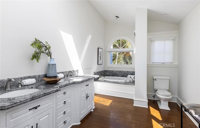 2163 Crestview Dr, Laguna Beach, CA 92651 - bathroom with wood-type flooring, vaulted ceiling, a garden tub, toilet, and double vanity