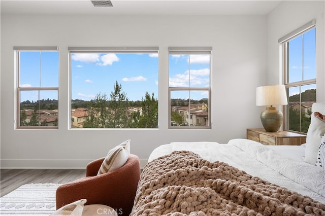 59 Longchamp, Irvine, CA 92602 - bedroom featuring wood finished floors, multiple windows, and baseboards