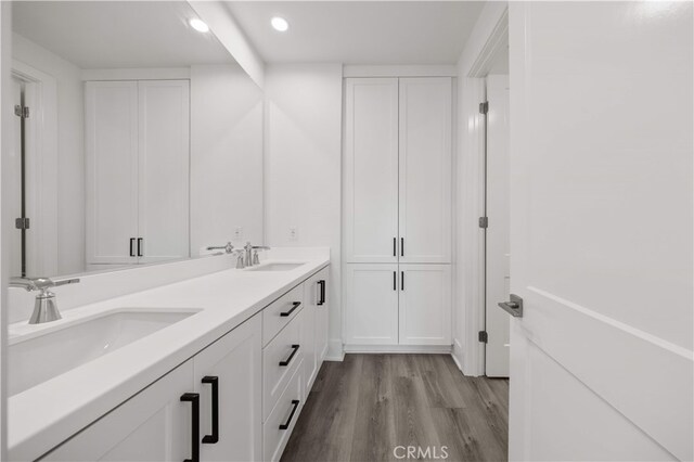 59 Longchamp, Irvine, CA 92602 - bathroom featuring wood finished floors, double vanity, and recessed lighting