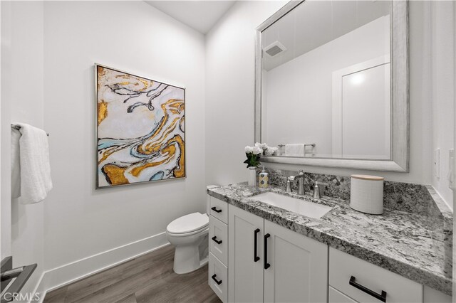 59 Longchamp, Irvine, CA 92602 - half bath featuring wood finished floors, vanity, toilet, and baseboards