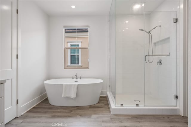 59 Longchamp, Irvine, CA 92602 - bathroom with a stall shower, wood finished floors, a freestanding bath, baseboards, and recessed lighting
