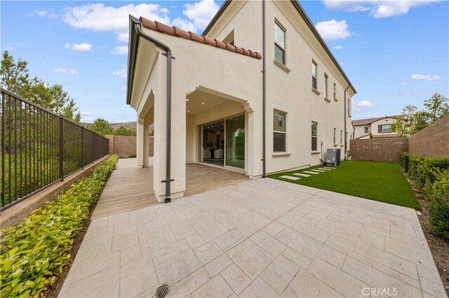59 Longchamp, Irvine, CA 92602 - back of house with stucco siding, a tiled roof, a patio, and central AC unit