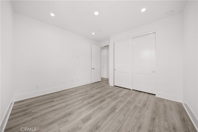 59 Longchamp, Irvine, CA 92602 - unfurnished bedroom featuring light wood-style floors, a closet, recessed lighting, and baseboards