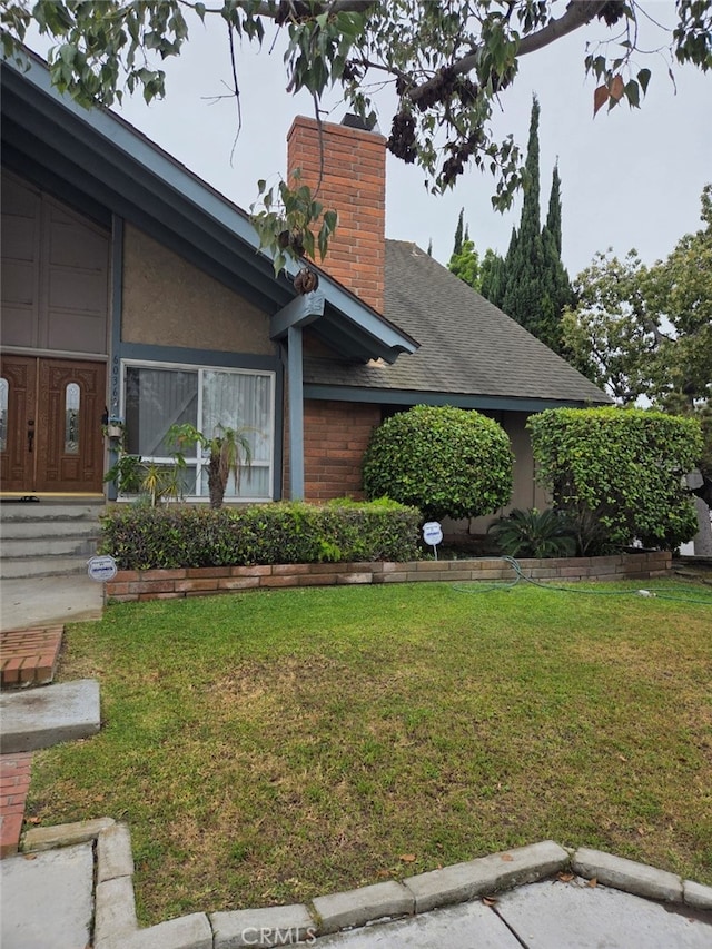 6036 Jeffrey Mark St, Cypress, CA 90630 - view of front of home with a front yard, a chimney, and roof with shingles