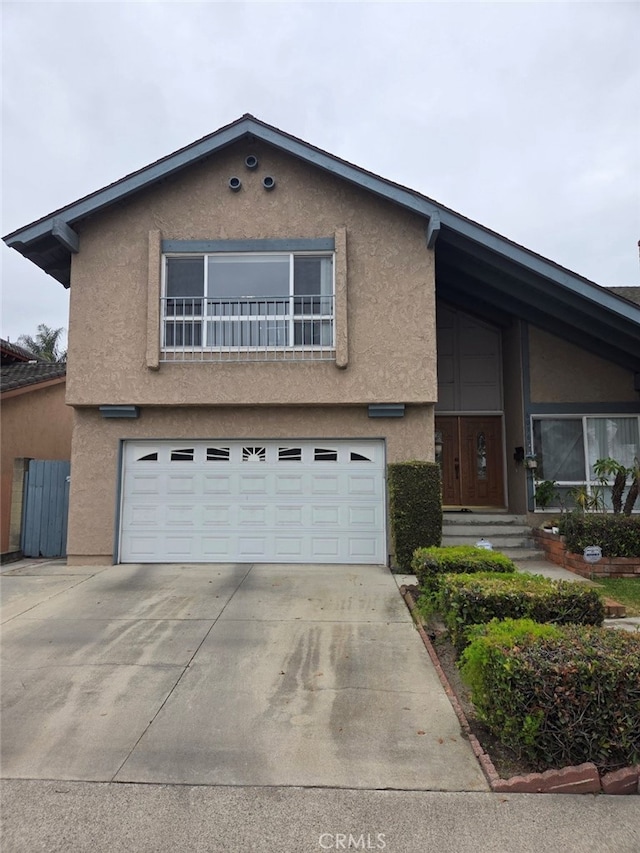 6036 Jeffrey Mark St, Cypress, CA 90630 - view of front of home featuring an attached garage, stucco siding, and concrete driveway