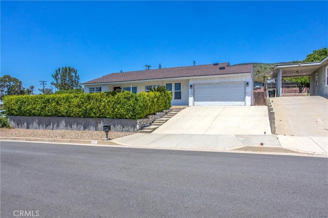 240 E 52nd St, San Bernardino, CA 92404 - single story home featuring an attached garage, concrete driveway, and stairs