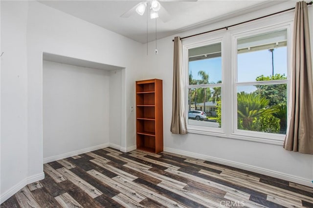 240 E 52nd St, San Bernardino, CA 92404 - unfurnished room with dark wood-style flooring, healthy amount of natural light, a ceiling fan, and baseboards