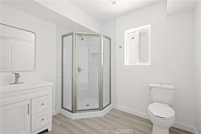 5218 Auckland Ave, Toluca Lake, CA 91601 - full bath with a marble finish shower, baseboards, toilet, and wood finished floors