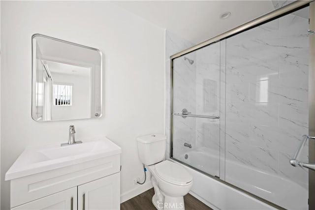 5218 Auckland Ave, Toluca Lake, CA 91601 - full bathroom featuring toilet, combined bath / shower with glass door, vanity, wood finished floors, and baseboards