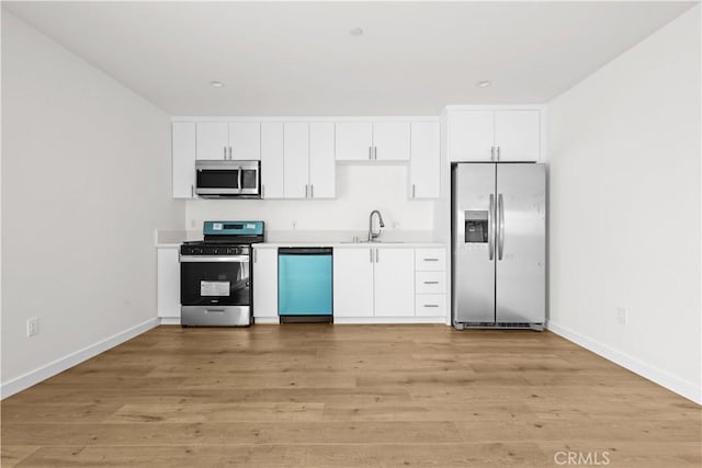 5218 Auckland Ave, Toluca Lake, CA 91601 - kitchen with stainless steel appliances, a sink, white cabinetry, baseboards, and recessed lighting