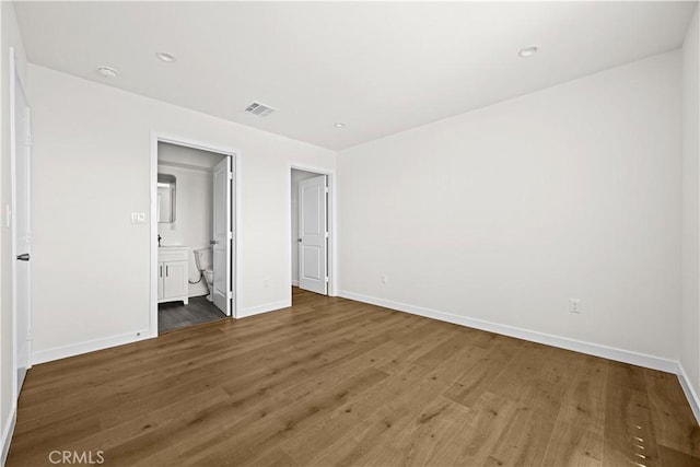 5218 Auckland Ave, Toluca Lake, CA 91601 - unfurnished bedroom featuring wood finished floors, baseboards, ensuite bathroom, and recessed lighting