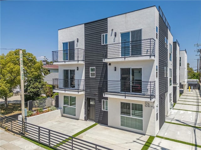 5218 Auckland Ave, Toluca Lake, CA 91601 - back of property with stucco siding, a balcony, and a patio area