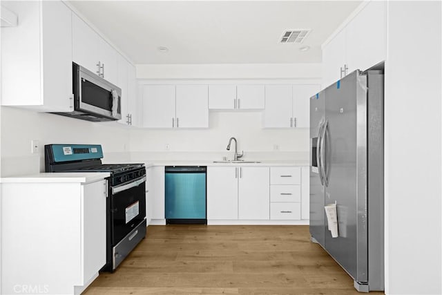 5218 Auckland Ave, Toluca Lake, CA 91601 - kitchen with stainless steel appliances, a sink, and light countertops