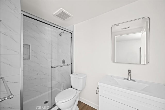 5218 Auckland Ave, Toluca Lake, CA 91601 - bathroom featuring a marble finish shower, toilet, vanity, and wood finished floors