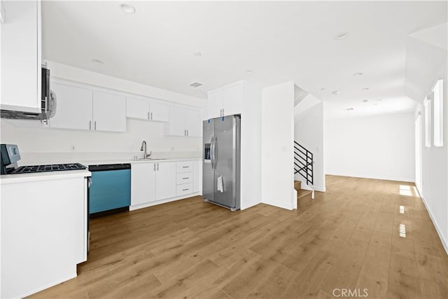5218 Auckland Ave, Toluca Lake, CA 91601 - kitchen featuring stainless steel fridge with ice dispenser, dishwashing machine, white gas range oven, a sink, and light countertops