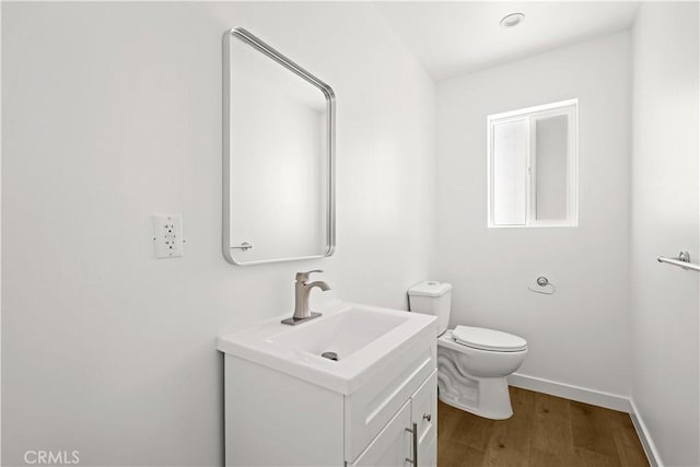 5218 Auckland Ave, Toluca Lake, CA 91601 - bathroom with wood finished floors, toilet, vanity, and baseboards
