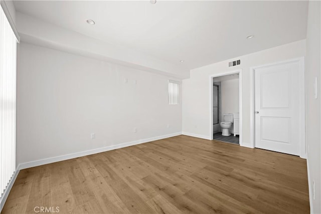 5218 Auckland Ave, Toluca Lake, CA 91601 - unfurnished bedroom with light wood finished floors, baseboards, and ensuite bathroom