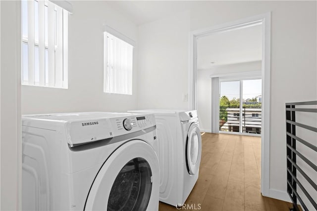 5218 Auckland Ave, Toluca Lake, CA 91601 - laundry room with washer and clothes dryer and wood finished floors