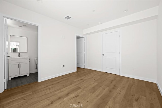 5218 Auckland Ave, Toluca Lake, CA 91601 - unfurnished bedroom with a sink, light wood-style flooring, and baseboards
