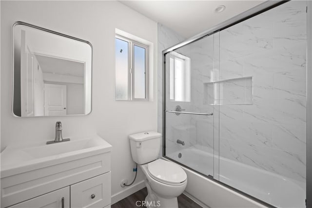 5218 Auckland Ave, Toluca Lake, CA 91601 - bathroom featuring toilet, vanity, baseboards, and bath / shower combo with glass door