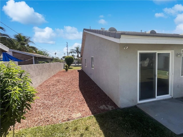 view of side of property with stucco siding