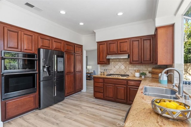 24882 Summerwind, Dana Point, CA 92629 - kitchen featuring black fridge, a sink, stainless steel gas cooktop, under cabinet range hood, and light wood-style floors