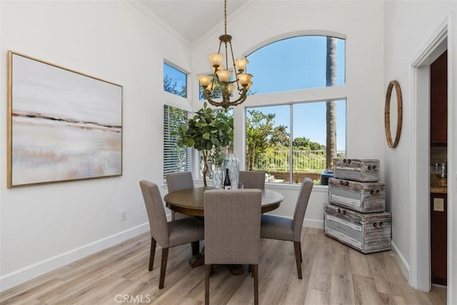 24882 Summerwind, Dana Point, CA 92629 - dining room with crown molding, a chandelier, light wood-style flooring, baseboards, and high vaulted ceiling