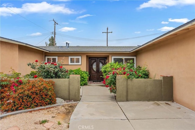 8535 La Vine St, Rancho Cucamonga, CA 91701 - doorway to property featuring stucco siding, french doors, and roof with shingles