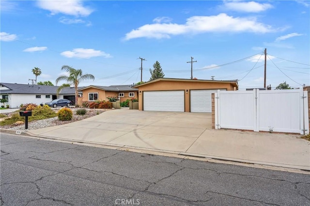 8535 La Vine St, Rancho Cucamonga, CA 91701 - view of front facade featuring stucco siding, driveway, an attached garage, and a gate