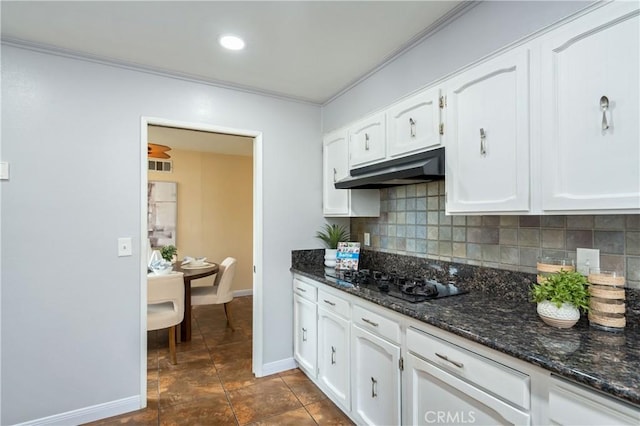 8535 La Vine St, Rancho Cucamonga, CA 91701 - kitchen with under cabinet range hood, black gas cooktop, decorative backsplash, white cabinets, and dark stone counters