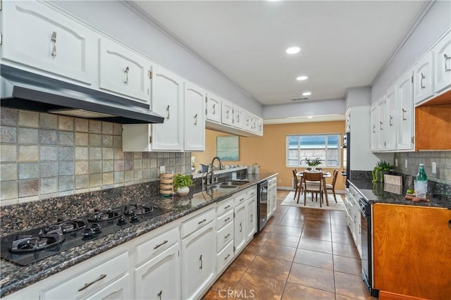 8535 La Vine St, Rancho Cucamonga, CA 91701 - kitchen featuring black appliances, under cabinet range hood, a sink, white cabinetry, and decorative backsplash