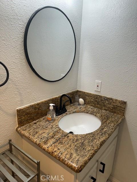 2400 Altisma Way Unit B, Carlsbad, CA 92009 - bathroom with vanity and a textured wall