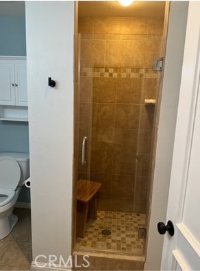 2400 Altisma Way Unit B, Carlsbad, CA 92009 - bathroom with tile patterned flooring, a stall shower, and toilet