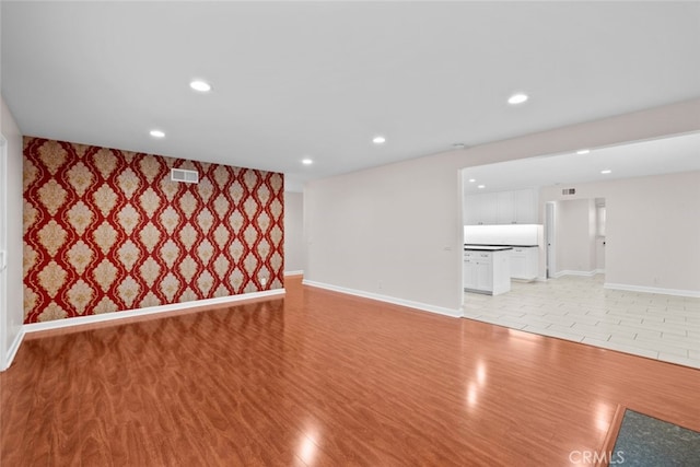 17148 Stare St, Northridge, CA 91325 - unfurnished living room with baseboards, light wood-style flooring, recessed lighting, and an accent wall