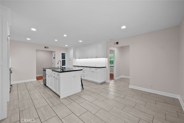 17148 Stare St, Northridge, CA 91325 - kitchen with dark countertops, a sink, white cabinetry, baseboards, and recessed lighting