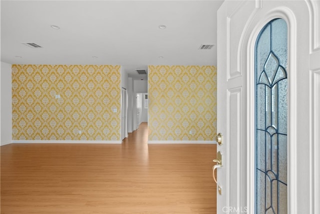 17148 Stare St, Northridge, CA 91325 - foyer with wallpapered walls, light wood-type flooring, baseboards, and an accent wall