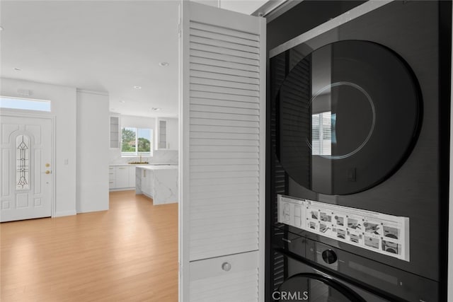 17148 Stare St, Northridge, CA 91325 - washroom with stacked washer / drying machine, light wood-type flooring, recessed lighting, and baseboards